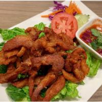 13. Beef Jerky · Deep fried marinated beef served with AM Thai spicy sauce. 