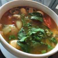 37. Tom Yum Noodle Soup · Rice noodle with shrimp, ground chicken, fish ball, onion, cilantro, crushed peanuts and bea...
