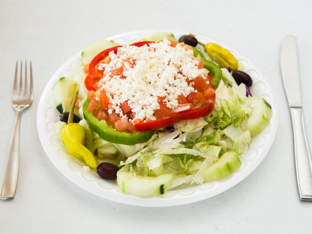 Greek Salad · Romaine and iceberg lettuce with red and green peppers, cucumbers, onions, tomatoes, kalamata olives and feta.  Served with garlic bread.