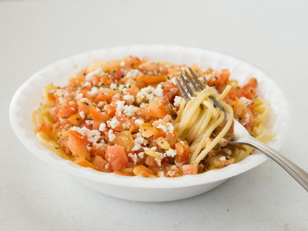Greek Spaghetti · Garlic butter, oregano and fresh-cut tomatoes served over pasta and topped with crumbled feta cheese. Served with a small Greek salad and garlic bread.