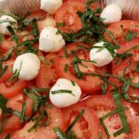 Insalata Caprese · Slices of fresh mozzarella, discs of vine-ripened tomatoes and fresh basil leaves topped wit...