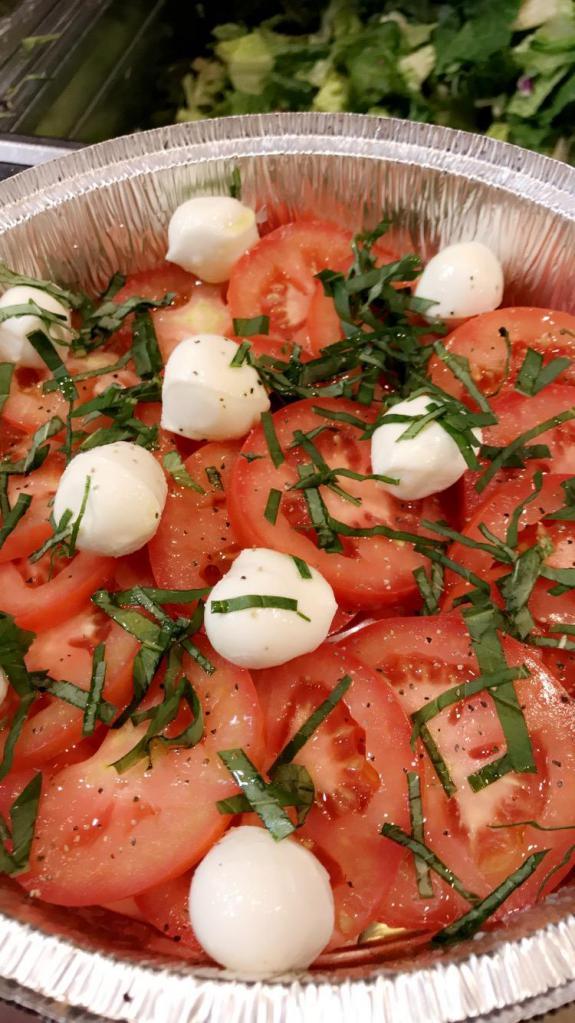 Insalata Caprese · Slices of fresh mozzarella, discs of vine-ripened tomatoes and fresh basil leaves topped with a dash of salt, pepper and Italy's finest extra virgin olive oil.