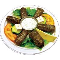 DOLMAS · Rice, parsley, mint and a twist of lemon juice wrapped in grape vine leaves. Vegetarian. Served with lettuce, tomatoes, cucumber and tzatziki sauce.