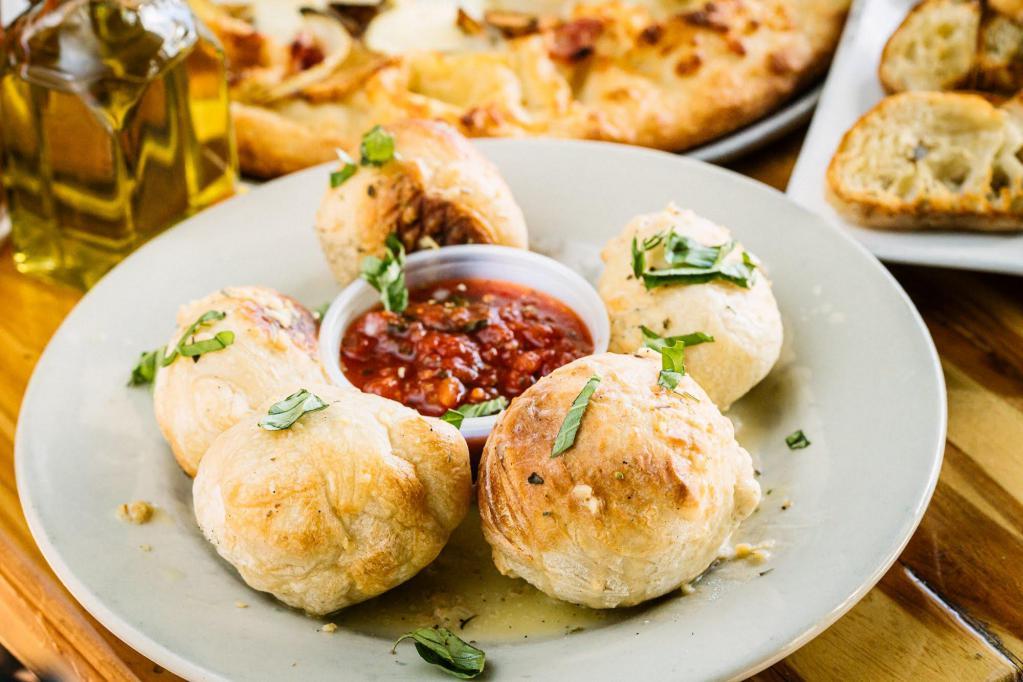 Garlic Knots · 5 fresh baked garlic knots, dressed with extra virgin olive oil, chopped garlic and seasoning. Served with our homemade marinara sauce.