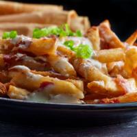Drunk Fries · Cut to order Yukon potato fries smothered in queso cheese. Topped with fresh chopped bacon, ...
