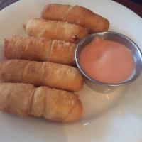 5 Piece Tequenos · Deep fried white cheese sticks wrapped in wheat flour dough.