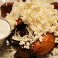 Tajadas con Queso · Sweet plantains with grated white cheese.