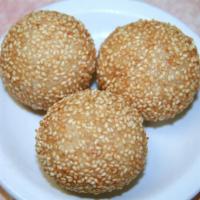 A14. Three Piece Sesame Balls · Lotus paste wrapped in sweet rice flour and dried with sesame seeds before fried.