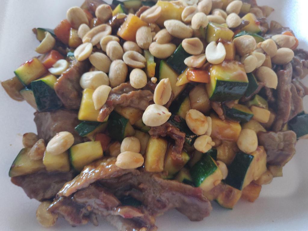 7. Kung Pao Beef · Beef stir-fried with zucchini, carrots, bamboo shoots, water chestnut in spicy brown sauce, topped with peanuts.