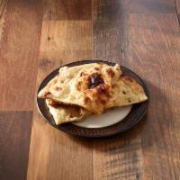 Plain Naan · Lightly fluffy white bread with crisp outside. A tandoori bread. Baked in clay oven.