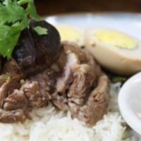 O1. Pork Leg over Rice · With mustard green, boiled egg and Chinese broccoli over rice.