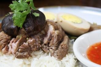 O1. Pork Leg over Rice · With mustard green, boiled egg and Chinese broccoli over rice.