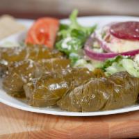 Dolmades Platter (4) with Greek Salad · Four authentic tender grape leaves stuffed with ground beef, rice, tomato and herbs, served ...