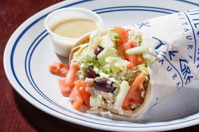 Veggie Wrap · Hummus, lettuce, tomato, onions, cucumber, olives and feta cheese with Greek dressing. Vegetarian.