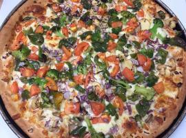 Veggie Pizza · Broccoli, tomatoes, mushrooms, red onions, green peppers on our regular pizza with cheese an...