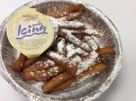 Funnel Cake Fries · Funnel cake in the shape of french fries, with powdered sugar and a side of icing.