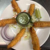Paneer Pakora · Thinly-sliced paneer (cheese) battered with chick-pea flour and spices and deep fried. A ver...