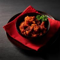 Gobi Manchurian · Lightly battered cauliflower deep fried and sauteed with sweet and hot sauce. Spicy.