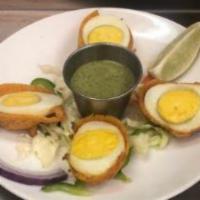 Egg Pakora · Shelled boiled Eggs battered with chick-pea flour and spices and deep fried. A very popular ...