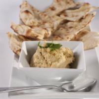 Hummus · Mashed chickpeas, tahini, olive oil and spices served with naan crisps.