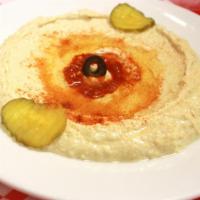 Hummus · Garbanzo beans mixed with your choice of sesame seed paste, lemon juice and garlic. Served w...
