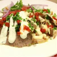 Combination Shawarma Plate · Served with basmati rice, green house salad, pita bread and sauce.