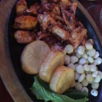 Pulpo Anticuchado · Octopus marinated in Peruvian spices served with golden potatoes and corn.