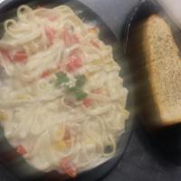 Fettuccine Alfredo · Parmesan cream sauce with meat. Served with garlic bread. contains bell peppers and Mushrooms