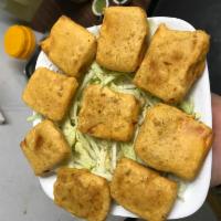 Paneer Pakoras · Slices of homemade cheese stuffed with fresh mint and spices dipped in chickpea batter and d...