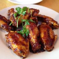 Wings · Crispy chicken wings glazed with house sweet and spicy sauce. 