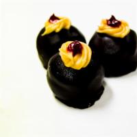 Chocolate Truffle · A rich chocolate truffle dipped in Swedish chocolate and raspberry on top.