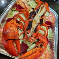 Langosta al Ajillo · Lobster in garlic butter sauce.