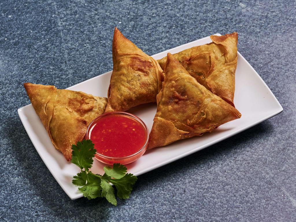 A1. 4 Piece Samosas · Hand wrapped and filled with curried potatoes, red onions, peas and carrots. Deep fried and served with our house special sauce.