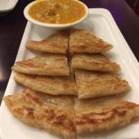 A2. Palata with Chicken dipping sauce · Homemade multi layered bread served with a coconut chicken curry.