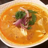 D2. Coconut Noodles Soup · Burmese style coconut noodle soup with chicken, onions, eggs, cilantro and lemon. Topped wit...