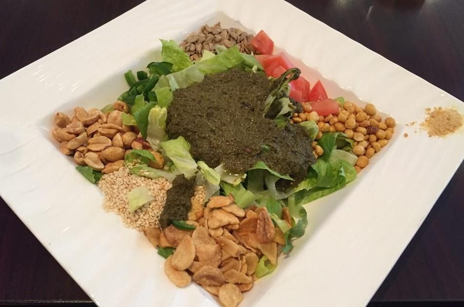 B1. Tea Leaf Salad · With romaine lettuce, fried yellow beans, fried garlic, sesame seeds, peanuts, sunflower seeds, fresh tomatoes, jalapenos and dried shrimp.