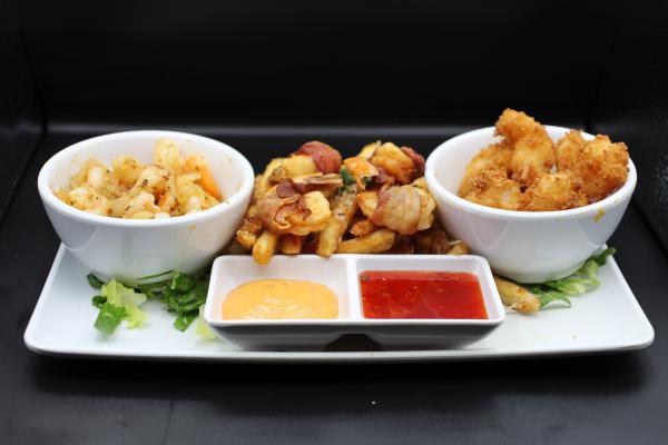 Shrimp Sampler · Shrimp 3 ways mojo, crispy coconut, wrapped in bacon laid on mojo fries with a chipotle aioli and sweet chili Thai dipping sauce.