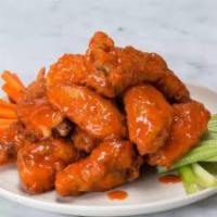 Buffalo Wings · Fried chicken wings tossed in hot sauce served with your choice of dip. Spicy.