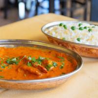 Butter Chicken · Tandoori chicken (boneless dark meat) pieces cooked in a tangy tomato sauce. Served with bas...