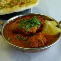 7. Karahi Gosht Curry · Goat meat with fresh tomatoes more taste and desi spices. Served with naan. Regular Spicy.