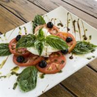 Caprese Salad · Tomatoes, fresh mozzarella, basil, extra virgin olive oil and black pepper.