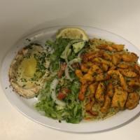 Chicken Shawarma Dish · Small stripes of chicken served with hummus, salad, and rice.