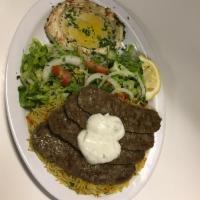 Gyro Dish · Beef gyro slices served with hummus, salad and rice.