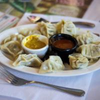 Meat Momos Appetizer · Steamed dumplings stuffed with chicken meat. Served 6 pcs with tomato achar (pickle).