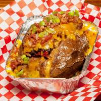 Loaded Smoked Spud · Butter, bacon pieces, sour cream, green onions, cheddar cheese and choice of meat.
