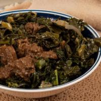 18. Gomen Besiga · Chopped collard greens mixed in mild Ethiopian sauce with beef. served on regular injera wit...