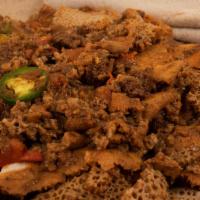 24. Tibs Fit Fit · Pieces of spiced beef cooked and served with pieces of injera all mixed together, Served on ...