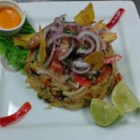 Arroz con Mariscos · Peruvian style paella. Fresh shellfish in a red pepper and green pea studded saffron rice.