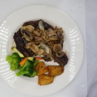 Bistecca Dello Chef · Charcoal grilled rib steak with sauteed onions, mushrooms and black truffle oil.