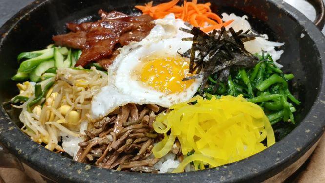 Gopdol Bibimbap DINNER · Lightly seasoned mixed vegetables, ground beef, fried egg over crisped rice from cooking in a hot stone bowl. Served with Miso Soup & gochujang red pepper sauce. CAN BE PREPARED VEGETARIAN. Very popular item.